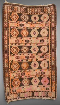 a brown and pink rug with a design on it