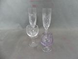 two wine glasses sitting next to each other on a table