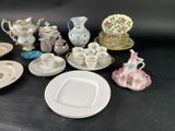 many different types of porcelain dishes and cups on the table