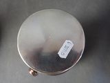a silver plate with a sticker on it sitting on a table