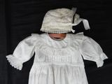 a white dress and a hat on a black background