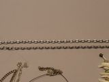 a lot of jewelry that is laying out on the table