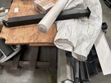 a table with a bunch of tools on it in a warehouse