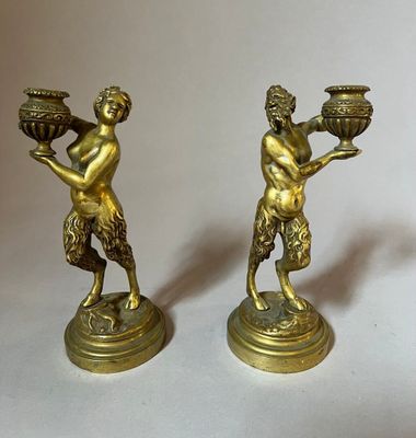 pair of antique brass figurines of a man and a woman holding pots
