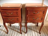 two wooden nightstands sitting next to each other on the floor