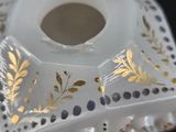 a glass candle holder with a gold leaf design on it