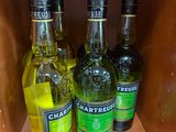 Plusieurs bouteilles d'alcool sont posées sur une étagère dans un magasin.