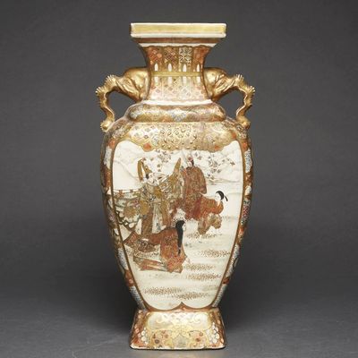 a vase with a painting on it sitting on a table