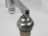 a close up of a metal object on a white surface
