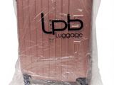a piece of luggage wrapped in plastic on a white surface