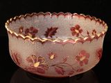 a close up of a bowl on a table with a black background