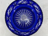 a blue glass plate with a starburst design on it