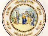 a plate with a picture of a group of people on it