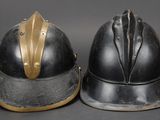 pair of helmets with gold trims on a gray background