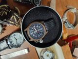a watch sitting in a box on a table with other watches
