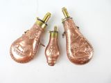 three copper colored lamps are sitting next to each other on a white surface