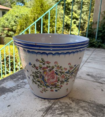 a blue and white flower pot sitting on a table