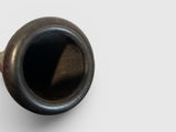 a black pipe sitting on top of a white table