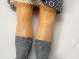 a close up of a doll with a blue dress and boots