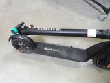 a scooter that is sitting on the floor in the garage