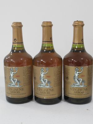 three bottles of wine sitting next to each other on a white surface