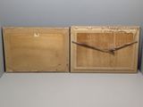 two wooden boxes with a clock on them on a table