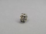 a silver bead with a square shaped design on it