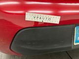 the back end of a red car with a sticker on it ' s bumper