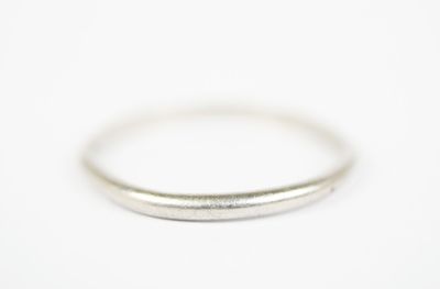 a close up of a silver ring on a white surface