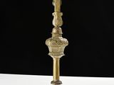 a gold cross with a crucif on top of it on a white table