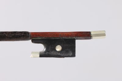 a violin bow with a wooden handle on a white surface