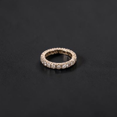 a diamond eternity ring on a black surface
