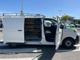 a white van parked in a parking lot with its doors open