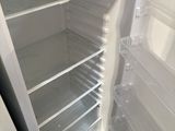 an empty refrigerator with the door open and no food inside