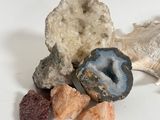 a pile of rocks and stones on a white surface