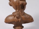 an image of a wooden bust of a woman on a pedestal