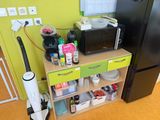 a small kitchen with a black refrigerator and green cabinets