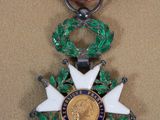 an image of a medal with a star on it on a brown surface