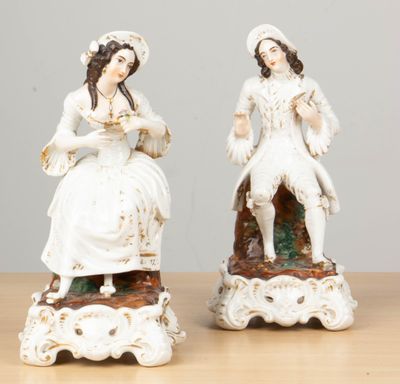 pair of antique porcelain figurines of a woman and a man