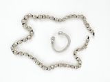 necklace, bracelet, and ring on a white background