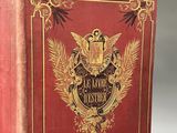 an old red book with gold trim and a golden crest on the cover