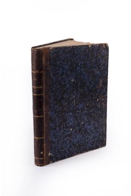 an old book with a blue cover on a white surface