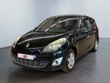 the small black car is parked in a large room