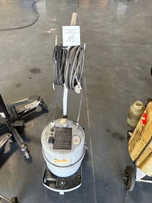 a machine that is sitting on the floor next to a chair