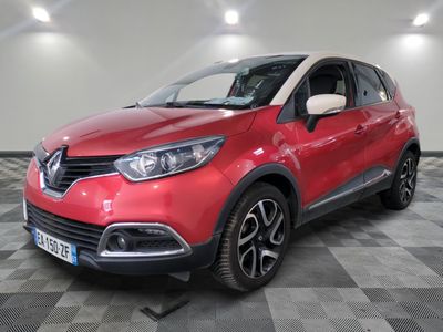 a red car parked on a checkered floor in a garage