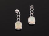 a pair of oplite and diamond earrings