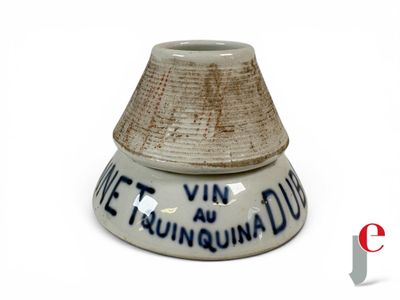 a small white vase with a blue writing on it