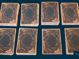 six decks of cards are arranged in a row on a blue background