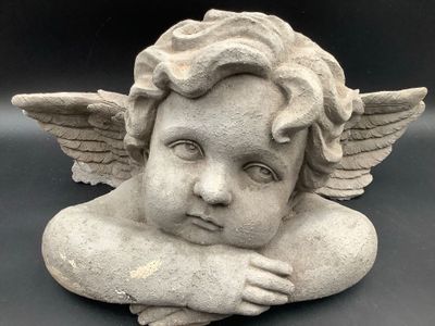 a statue of a little angel with wings on it ' s head