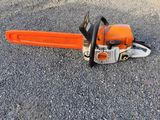a close up of a chainsaw on the ground on the ground
